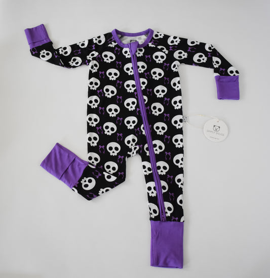 Baby pajama with skull pattern and purple accents 
