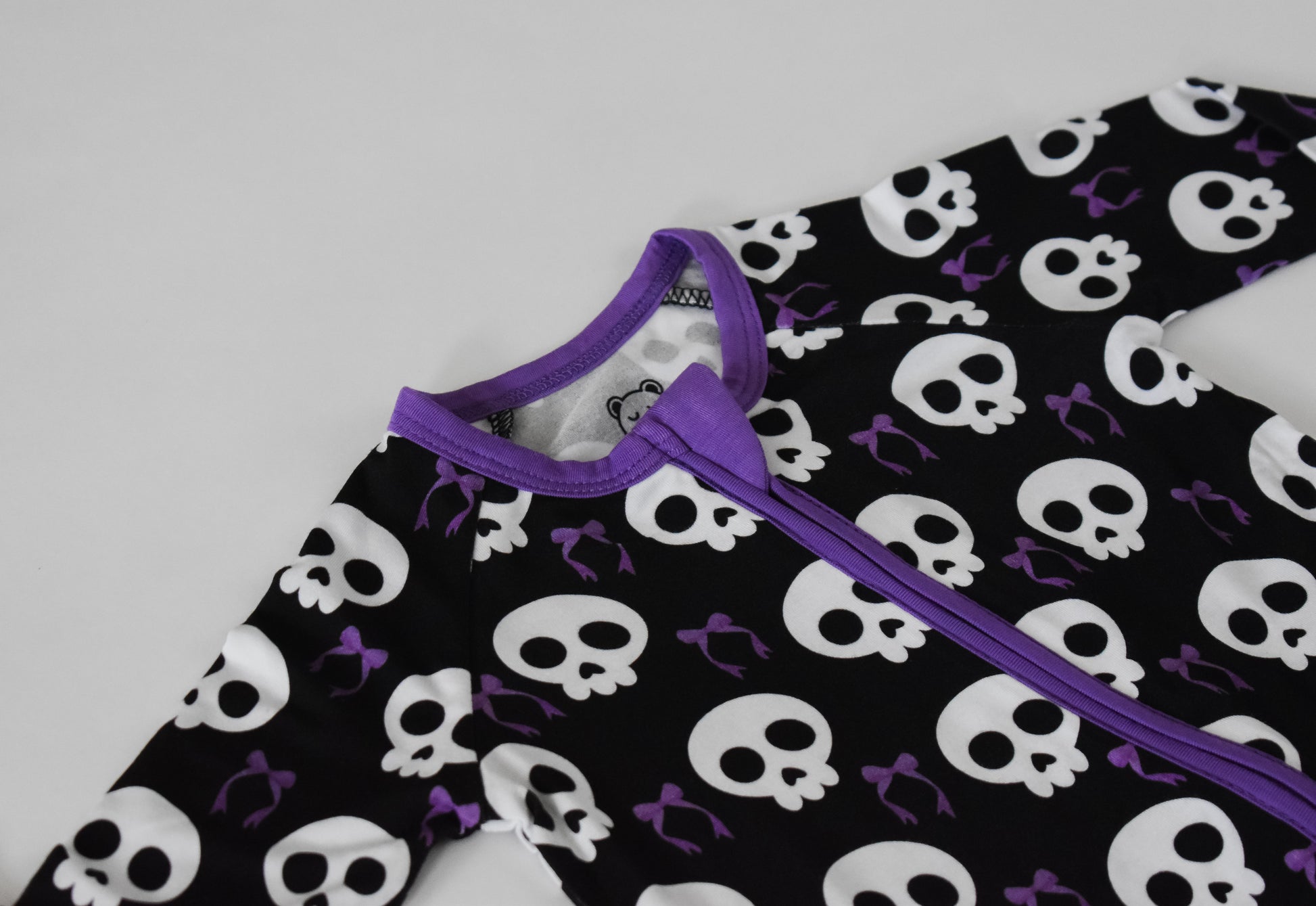Skulls and bows purple footie pajama