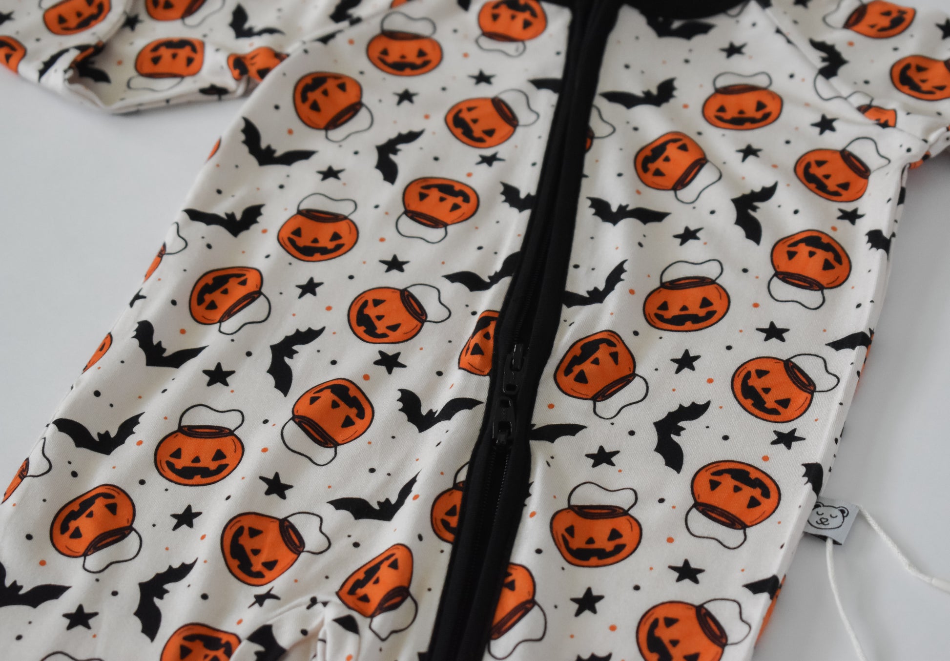 Baby pajama with Halloween-themed pattern and double zipper