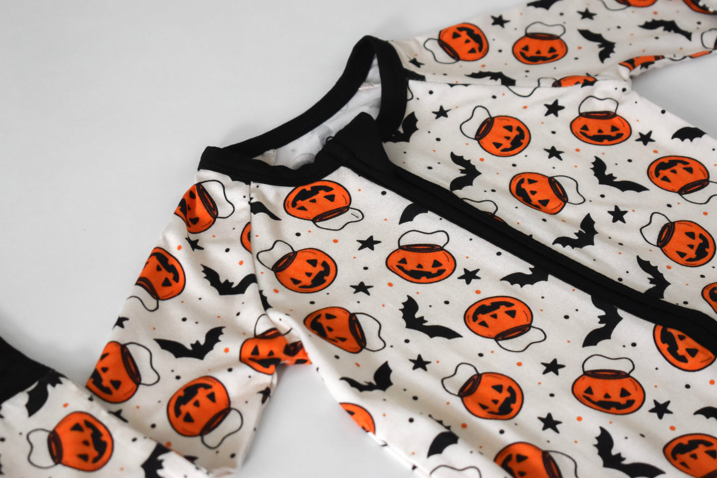 Halloween-themed baby pajama with pumpkins and bats