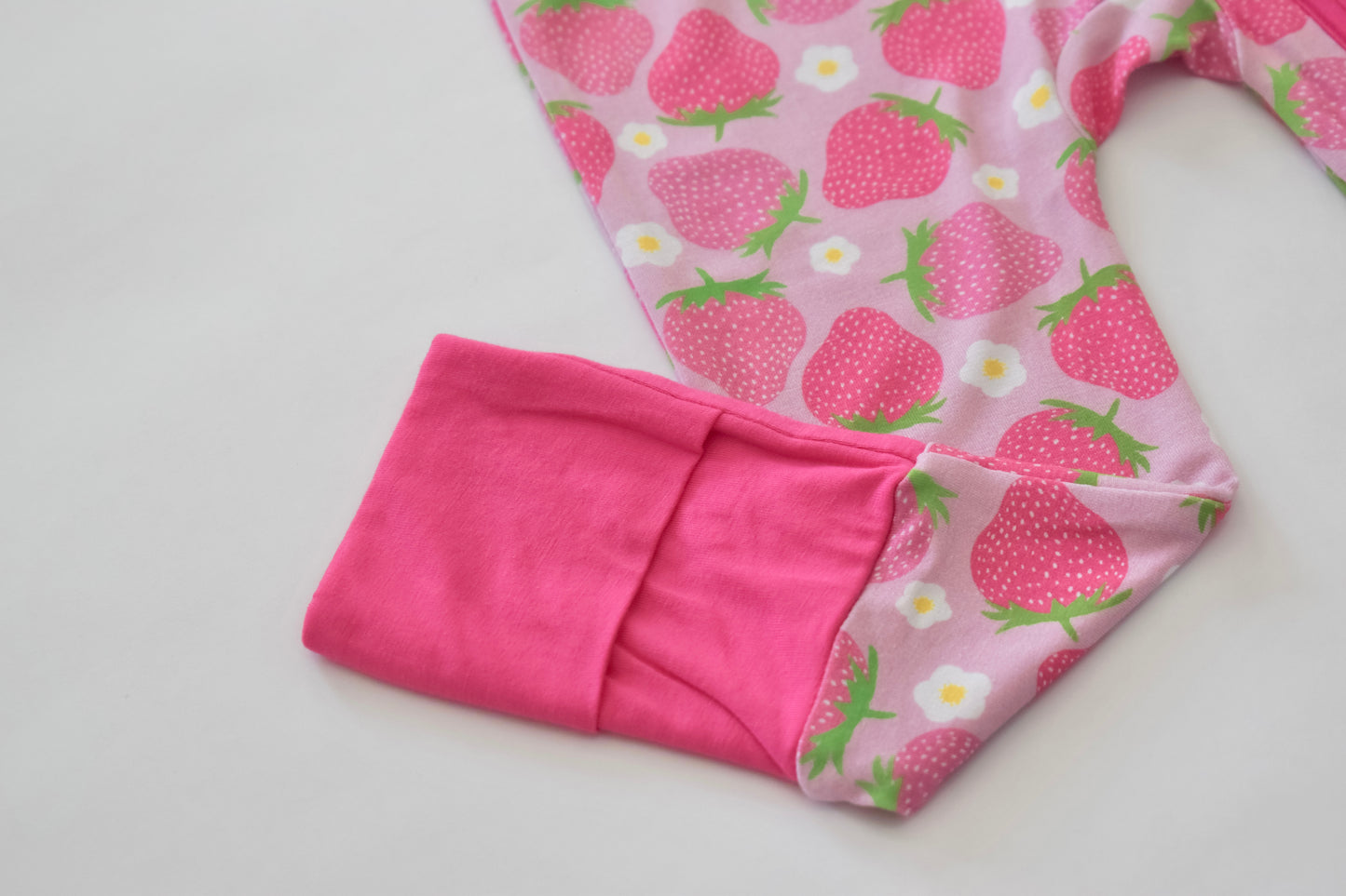 Folded pink pajama with strawberry pattern