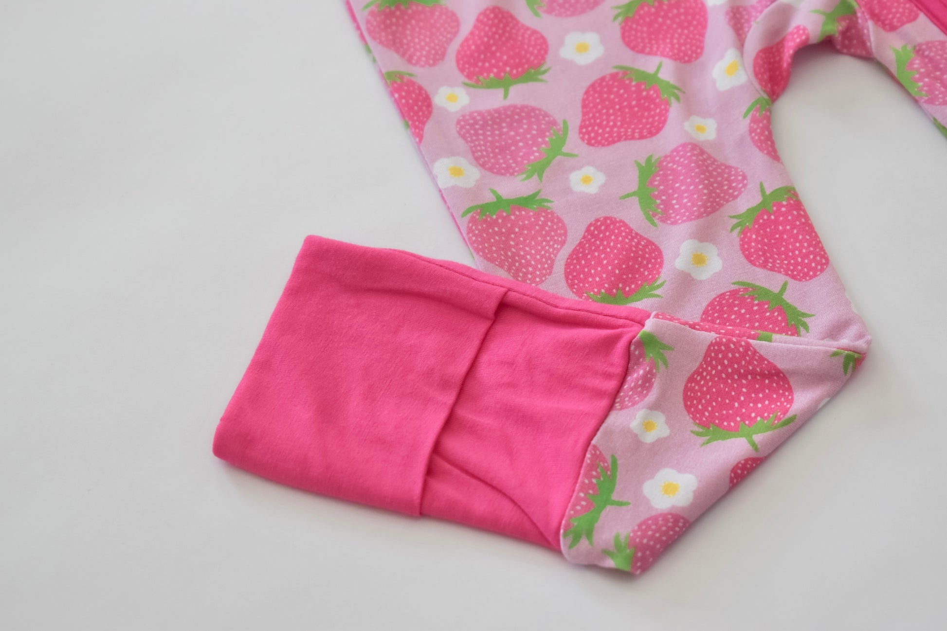 Folded pink pajama with strawberry pattern