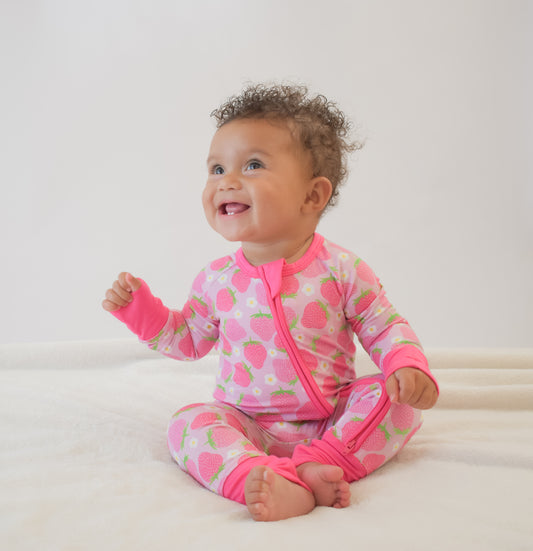 Happy baby wearing a pink strawberry convertible pajama with double zipper 