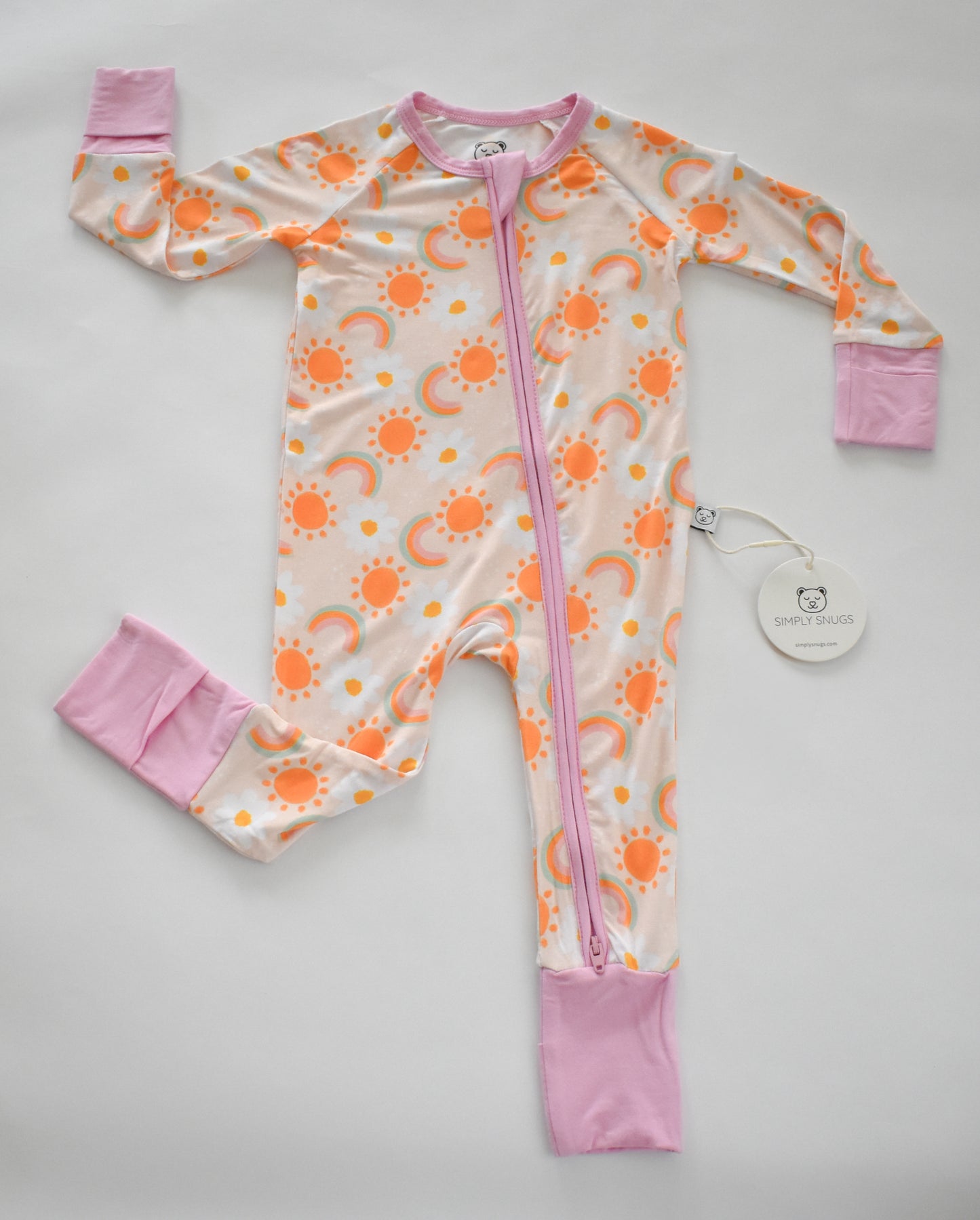 Baby romper with sun pattern and pink accents