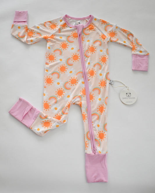 Baby romper with sun pattern and pink accents